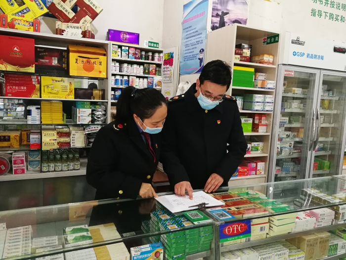 圖為鷹潭市市場監管局執法人員正在核對藥品零售企業銷售發熱、止咳等藥品的實名登記記錄