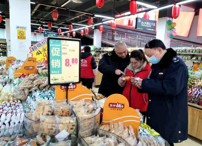 圖為執法人員在檢查散裝餅干的生產日期。（王玲玲 攝）