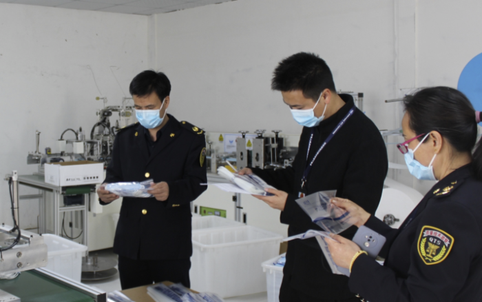 圖為執法人員在一家醫用口罩生產企業檢查。