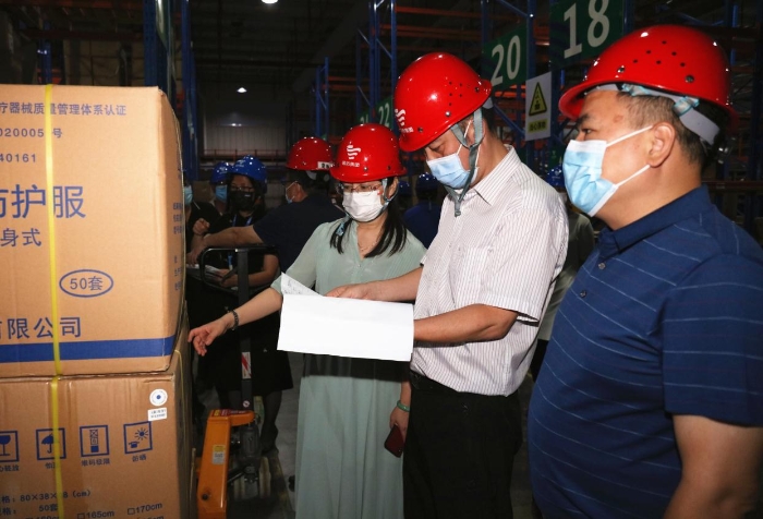 圖為檢查組在企業醫用防護服生產車間檢查